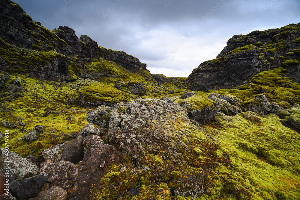 Ominous volcanic landscape and heavy clouds on a trail near Tjarnargígur crater pond, and through the bright green moss-covered crater row and lava fields of Lakagígar, Iceland
Ominous volcanic landscape and heavy clouds on a trail near Tjarnargígur crater pond, and through the bright green moss-covered crater row and lava fields of Lakagígar, Iceland