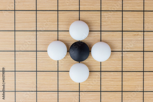 Training simple position of black and white stones on the playing field (gohan) of traditional Chinese strategy game go