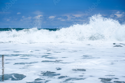 A wave crashes on the horizon in the distance at Blowing Rocks in Florida.