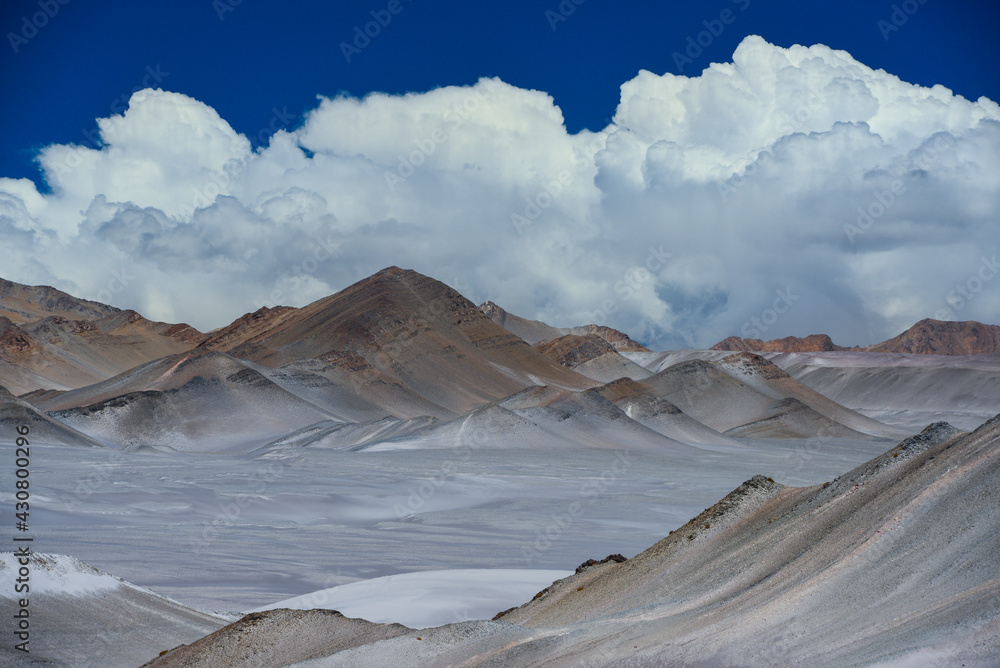 The arid and remote altiplano landscape around the Campo de Piedra Pomez, or Pumice Stone Field, and a cumulonimbus cloud, El Peñon, Catamarca, Argentina