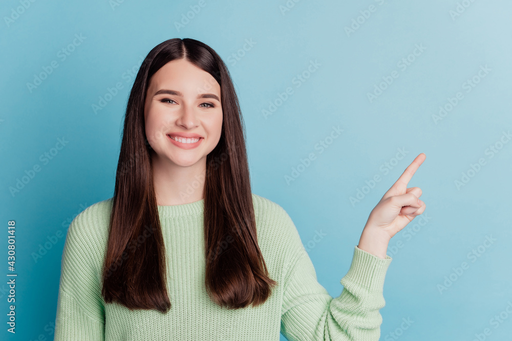 Portrait of a charming promoter girl pointing finger empty space Portrait of a charming promoter girl pointing finger empty space