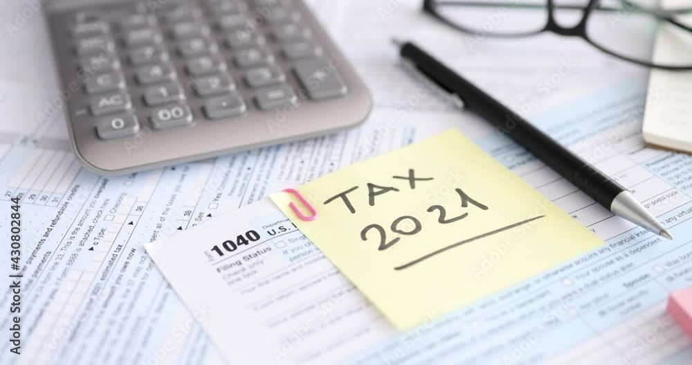 Tax form lying near ballpoint pen and calculator 4k movie Tax form lying near ballpoint pen and calculator 4k movie