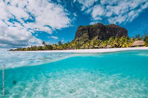 Fototapeta Naklejka Na Ścianę i Meble -  Tropical blue ocean with Le Morne mountain and luxury beach in Mauritius. Split view.