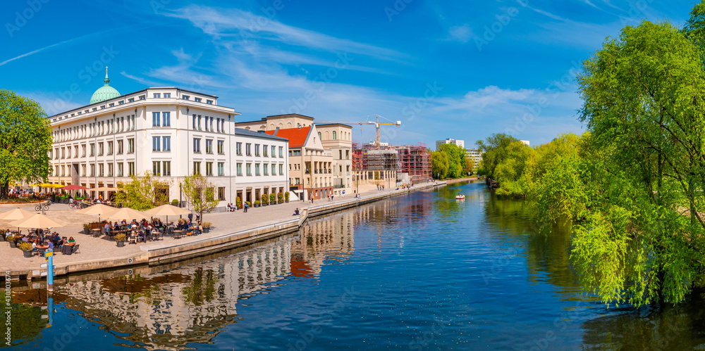 Panoramic view of historical downtown in Potsdam with river Havel and cafes and restaurants at blue sky in Spring, Germany.