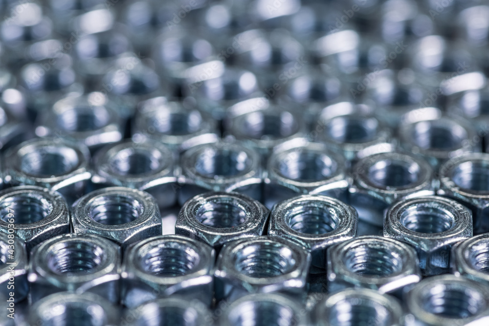 Close-up chrome metal nuts in the form of honeycombs