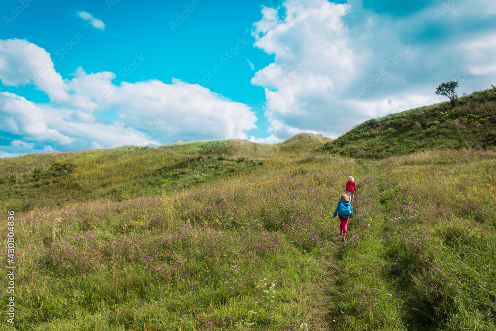 kids hiking in nature, little girls enjoy scenic view, active lifestyle