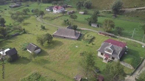 Aerial view old Grazhda Hut - typical gucul homestead, when residential and commercial premises interconnected and closed rectangular courtyard, Carpathian village Kryvorivnia, Ukraine photo