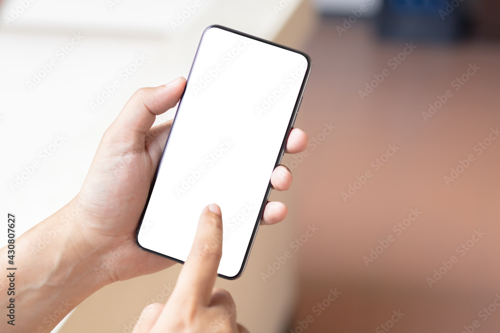 Hand holding and using smartphone with white blank on screen. Hand holding and using smartphone with white blank on screen.