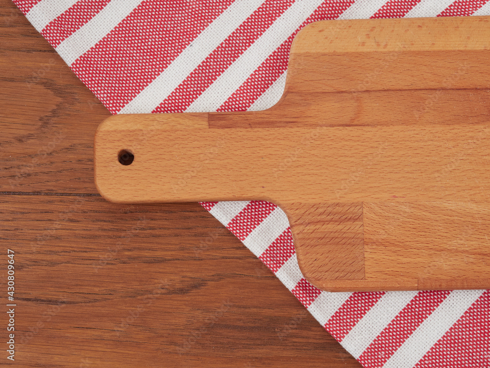 Fototapeta premium Cutting board or chopping board on wooden table. Wooden plate on desk. Top view