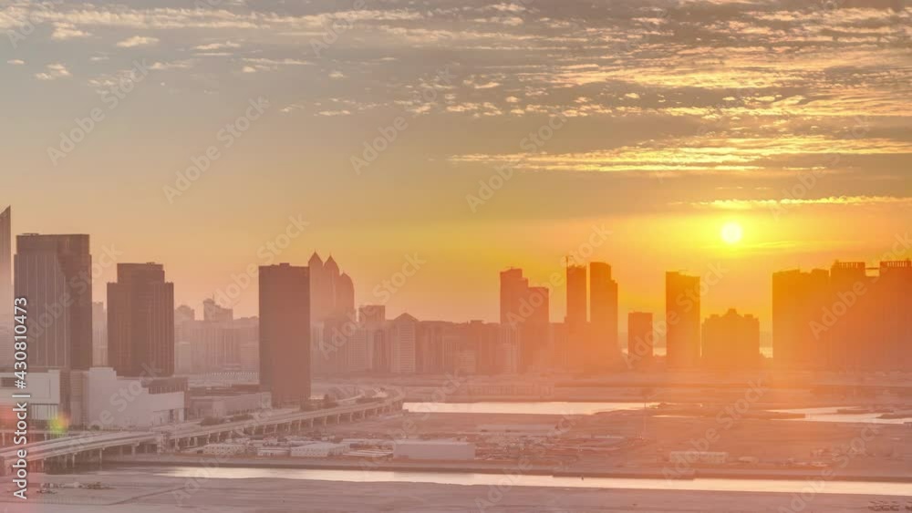 Buildings on Al Reem island in Abu Dhabi at sunset timelapse from above.