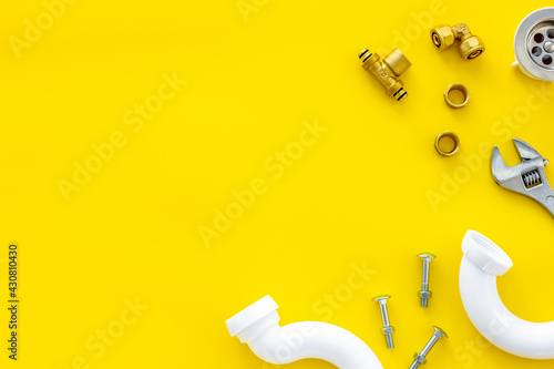 Plumber work with instruments, tools and gear on yellow background top view mockup photo