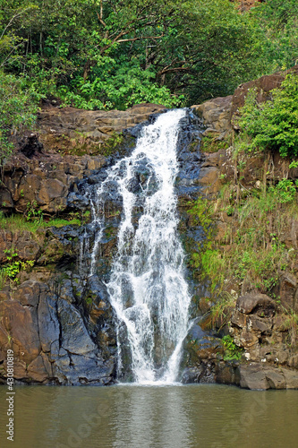 Beautiful tropical waterfall in Waimea Valley park on Oahu island photo