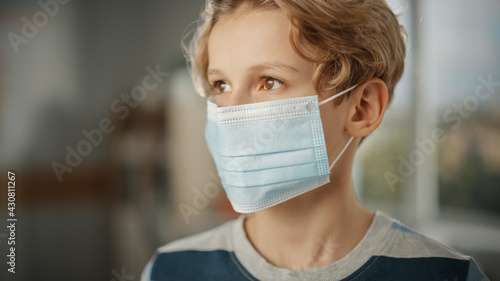Portrait of a Handsome Stylish Young Boy Wearing Protective Face Mask Indoors. Brown Eyed Blonde Haired Male Respects Quarantine Rules, Lockdown Measures and Safe Social Distancing. Pandemic Concept.