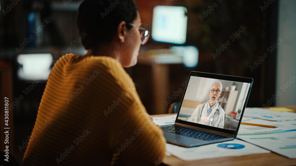 Beautiful Multiethnic Latina Manager is Making Video Call to His Doctor on Laptop in a Creative Office Environment. Man is Talking to His Medical Consultant Over a Live Camera, Asking about Health. Beautiful Multiethnic Latina Manager is Making Video Call to His Doctor on Laptop in a Creative Office Environment. Man is Talking to His Medical Consultant Over a Live Camera, Asking about Health.