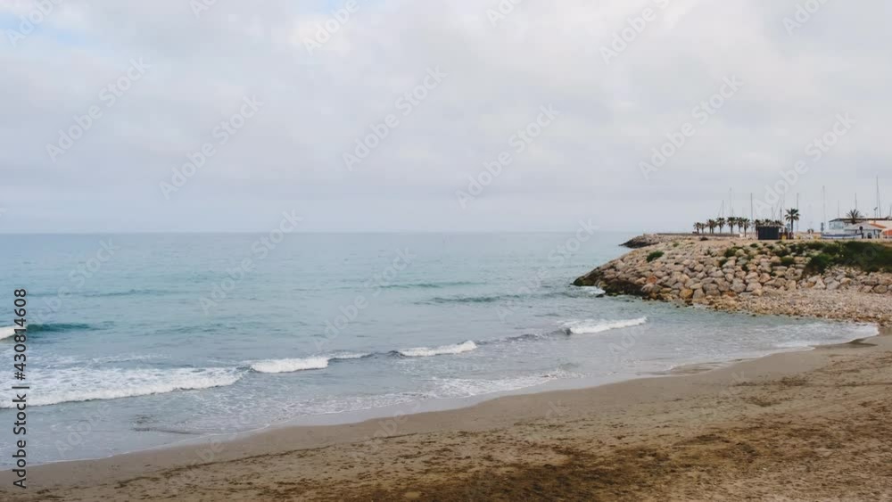 Calm sea, beach without people, cloudy day, Spain 2021 Calm sea, beach without people, cloudy day, Spain 2021