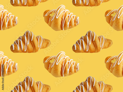 Fresh croissant seamless pattern isolated on orange background. Place for your text. Croissant seamless pattern on yellow background. Background texture baking croissant.