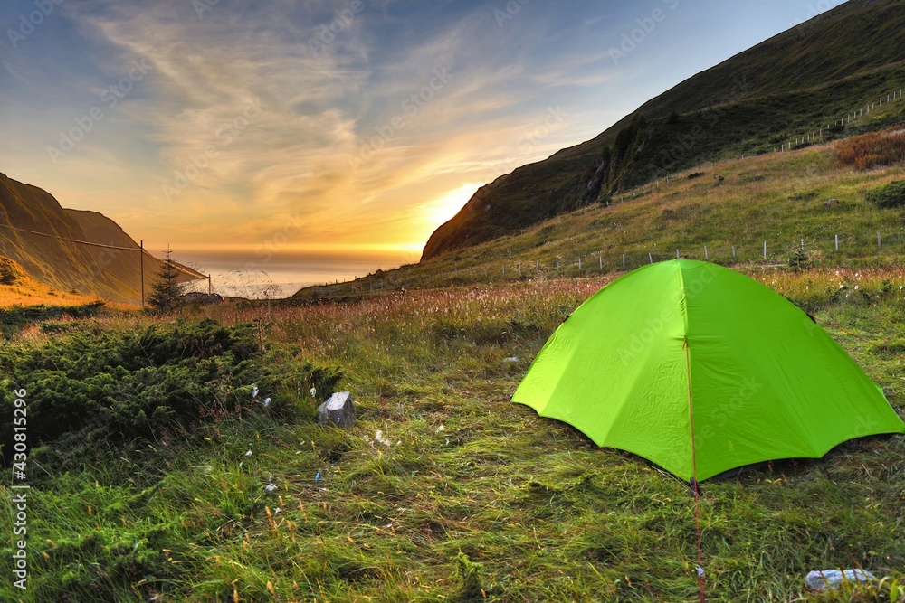 Norway camping adventure. Green tent camping site. Outdoor vacation in Norway.