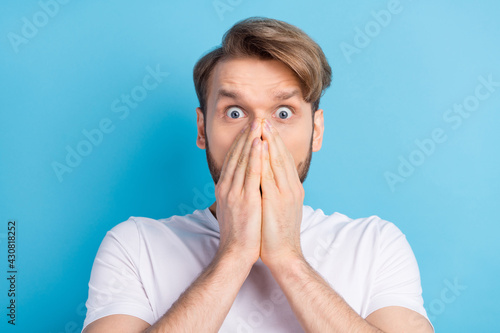 Photo portrait of guy wearing casual outfit cover face staring amazed got trouble isolated bright blue color background