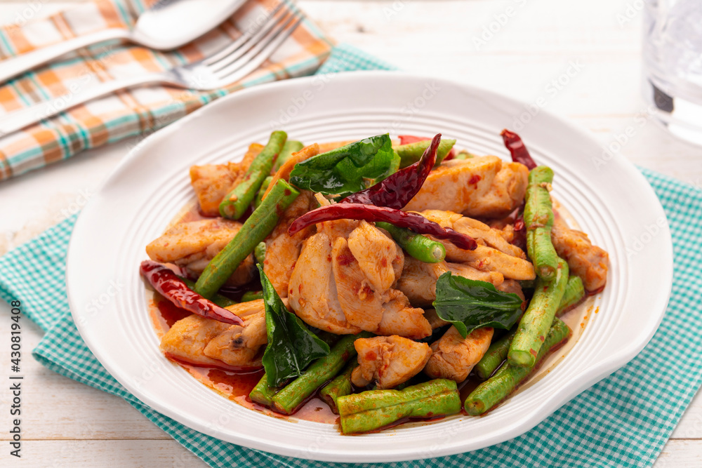 Yardlong bean and chicken chunks, stir fried with curry paste, simple to make, but is a favorite savory dish for many Thais. Yardlong bean and chicken chunks, stir fried with curry paste, simple to make, but is a favorite savory dish for many Thais.