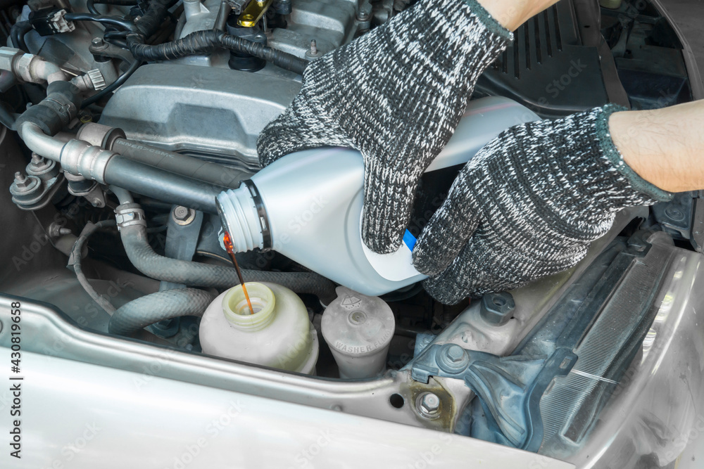 Pouring new steering fluid to old car engine, Car service.