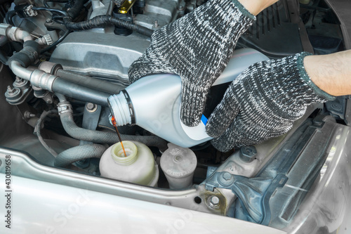 Obraz na płótnie Pouring new steering fluid to old car engine, Car service. w salonie