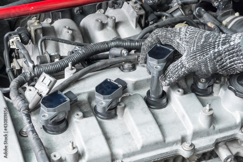 Auto mechanic Installing modify ignition coil on car engine, Car Modify, Car maintenance service.