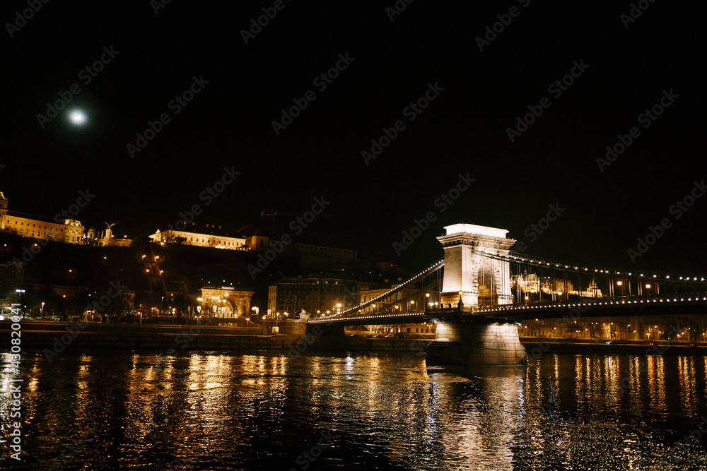 Night view of the Szechenyi chain bridge in Budapest with illumination