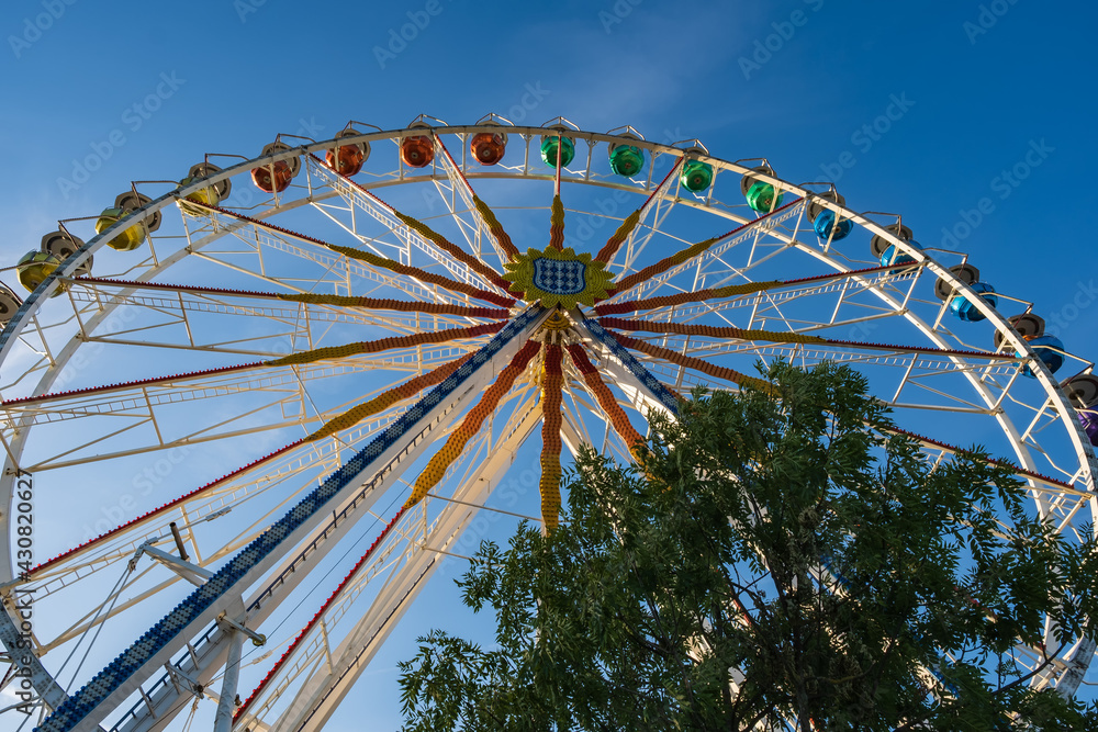 View up to a pretty ferris wheel against a blue sky in Wiesbaden / Germany on the banks of the Rhine View up to a pretty ferris wheel against a blue sky in Wiesbaden / Germany on the banks of the Rhine