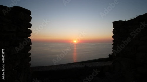 Ruins of Castello della Valle overlooking the Tyrrhenian Sea at sunset, an old castle in Fiumefreddo Bruzio, Calabria, south Italy photo