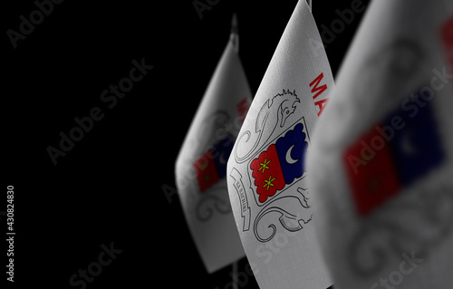 Small national flags of the Mayotte on a black background photo