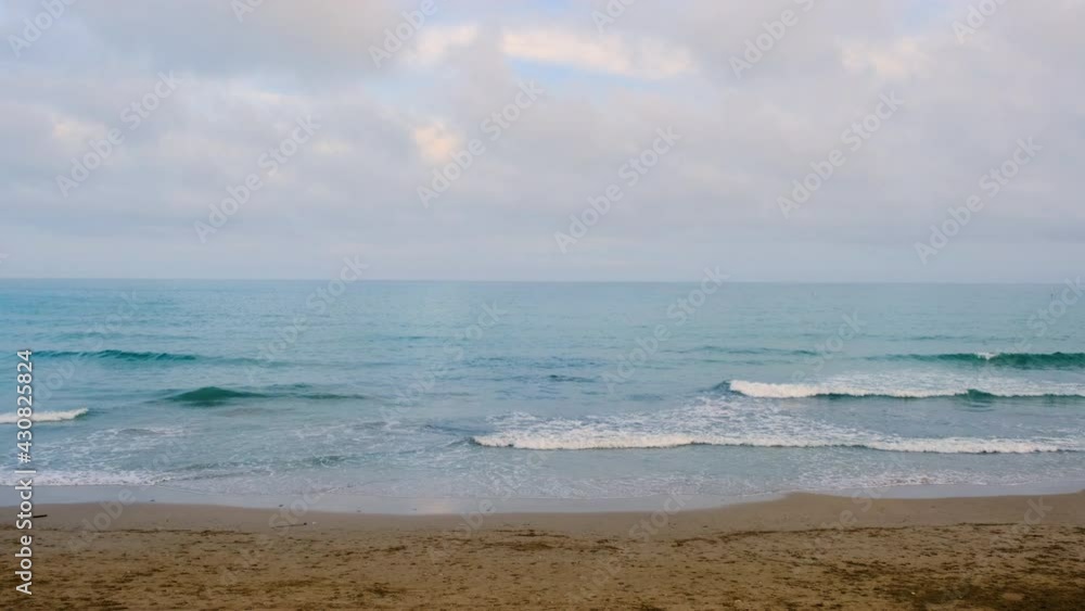 Sea slow motion. Calm sea, beach without people, empty beach, cloudy day, Spain 2021 Sea slow motion. Calm sea, beach without people, empty beach, cloudy day, Spain 2021