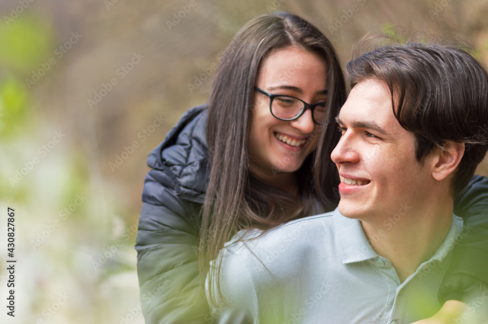 Close up of smiling young couple having an great time outdoors,side view with bllured backgound Close up of smiling young couple having an great time outdoors,side view with bllured backgound