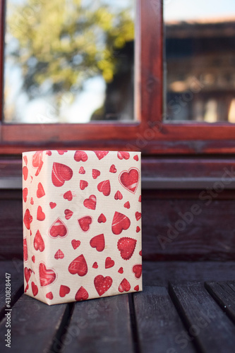 Rectangular gift box wrapped with heart paper
