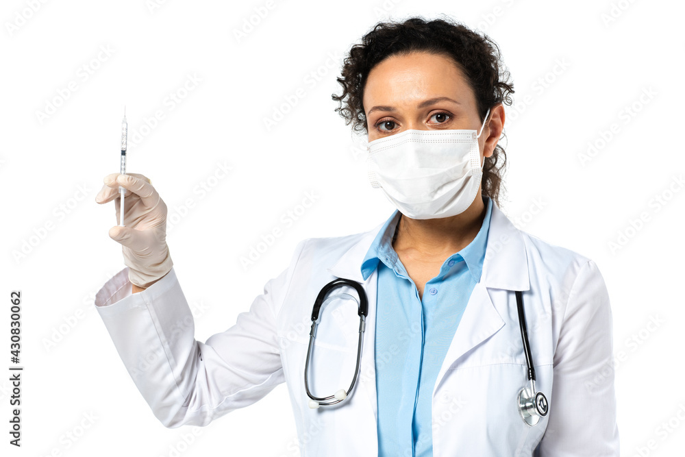 African american doctor in medical mask holding syringe with vaccine isolated on white African american doctor in medical mask holding syringe with vaccine isolated on white