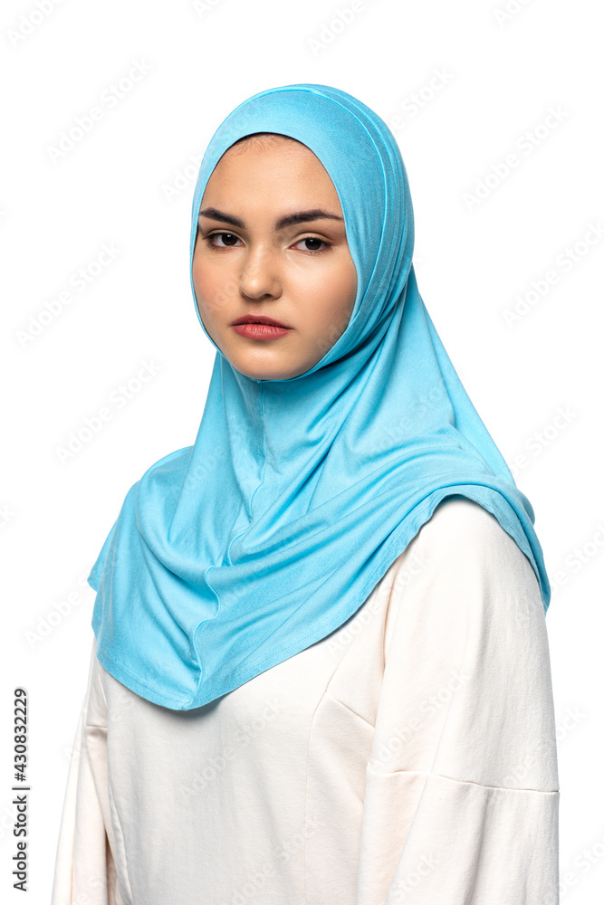 Muslim woman in hijab looking at camera isolated on white Muslim woman in hijab looking at camera isolated on white