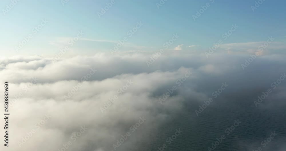 Flying through amazingly beautiful cloudscape. Picturesque timelapse of white fluffy clouds moving softly on the clear blue sky. Direct view from the cockpit.
