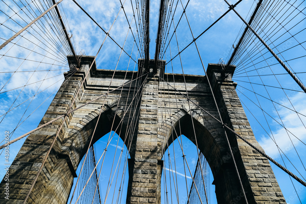 Obraz premium Low angle view of Brooklyn Bridge in New York City. Iconic View of NYC