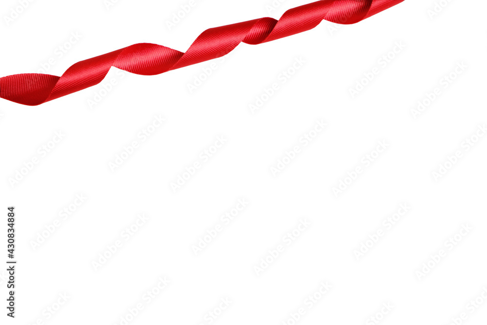 Red ribbon twisted in a spiral on a white background. Red ribbon twisted in a spiral on a white background.