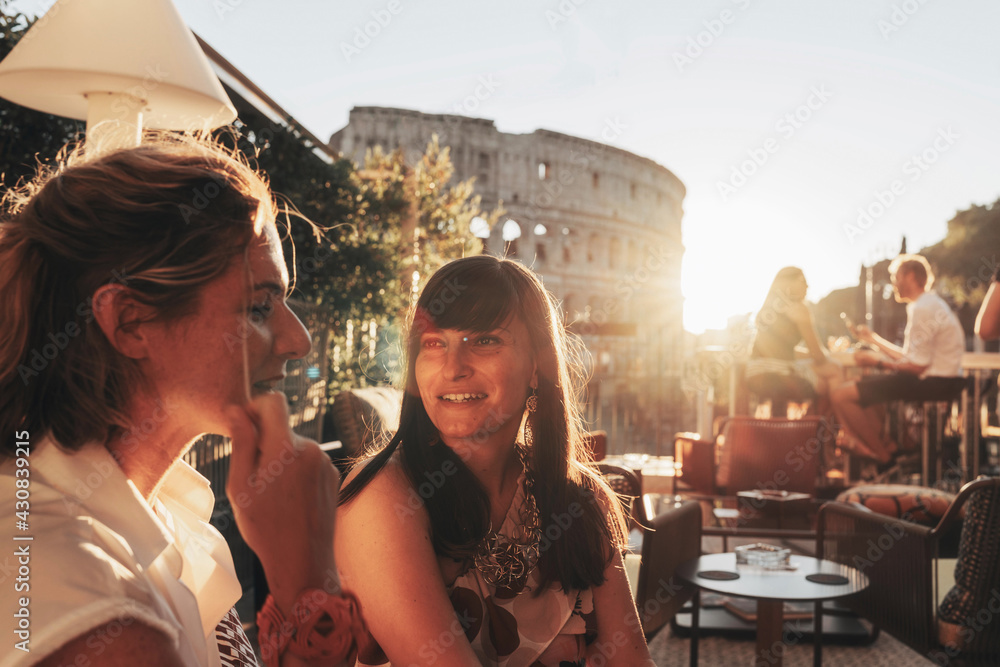Two smiling women at sunset in Rome, Italy. Happy Hour