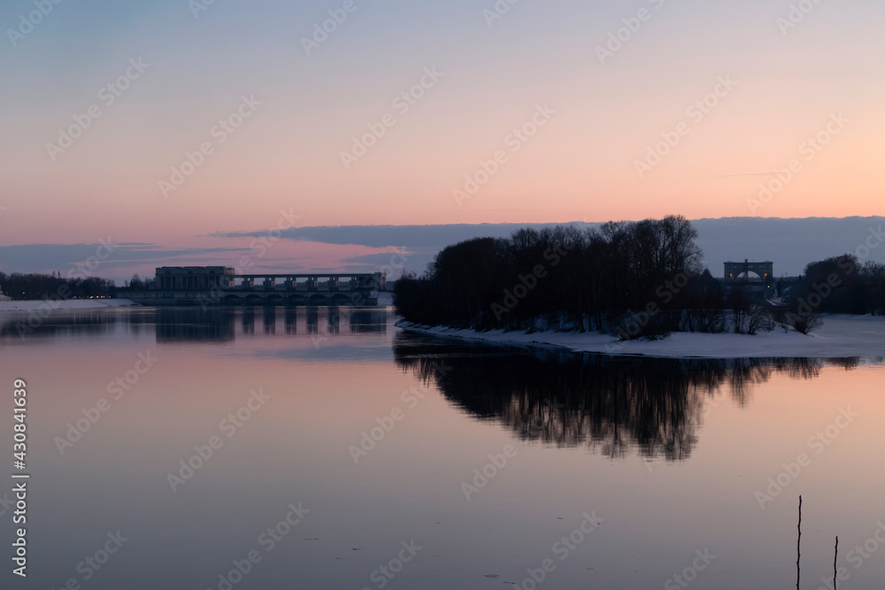 View of the hydroelectric dam and sluice in Uglich in spring, at sunset.