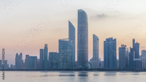 Wallpaper Mural Abu Dhabi city skyline with skyscrapers before sunrise with water reflection night to day timelapse Torontodigital.ca