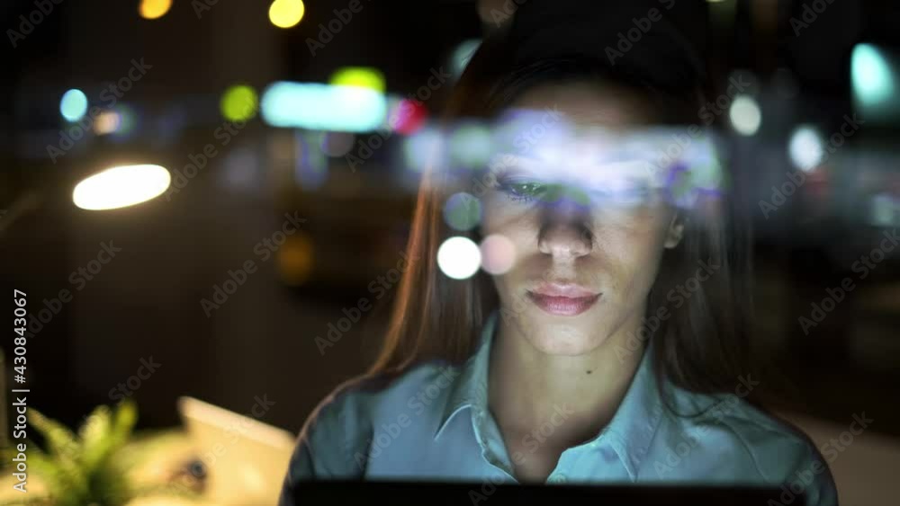 Video of smart pretty business woman taking a break while cheaking her digital tablet standing in the office at night. Video of smart pretty business woman taking a break while cheaking her digital tablet standing in the office at night.