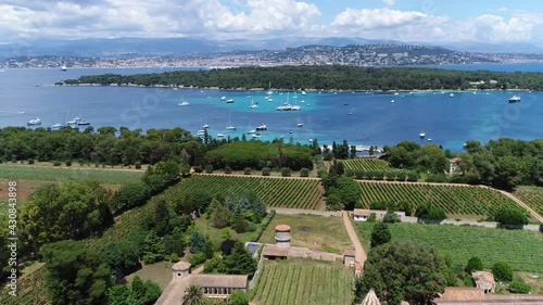 Aerial view of Ile Saint Honorat is the second largest of the Lérins Islands about a mile off shore from the French Riviera town of Cannes in the background also showing Sainte Marguerite 4k quality