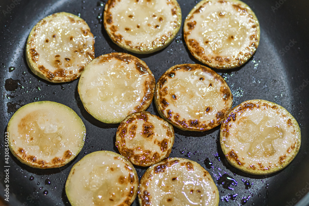 Fried zucchini in a frying pan. top view, close-up Fried zucchini in a frying pan. top view, close-up