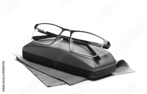 New black eye glasses, cleaning cloth and case isolated on white background