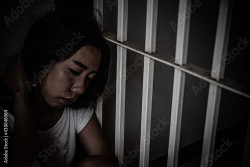 Women desperate to catch the iron prison,prisoner concept,thailand people,Hope to be free,If the violate the law would be arrested and jailed.