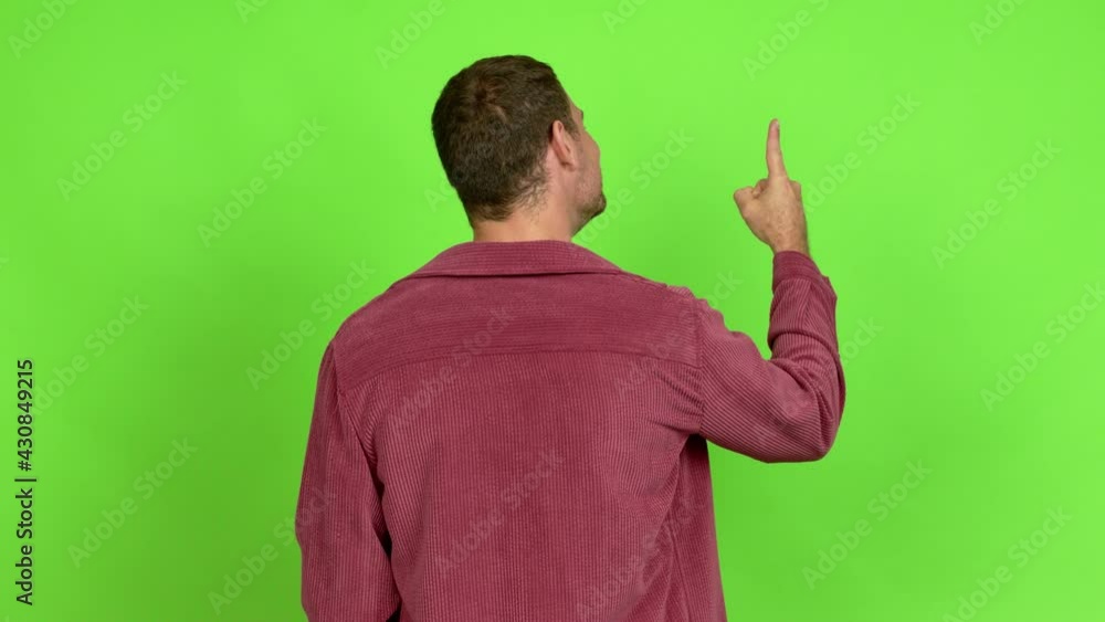 Brazilian handsome man pointing back with the index finger over isolated background Brazilian handsome man pointing back with the index finger over isolated background