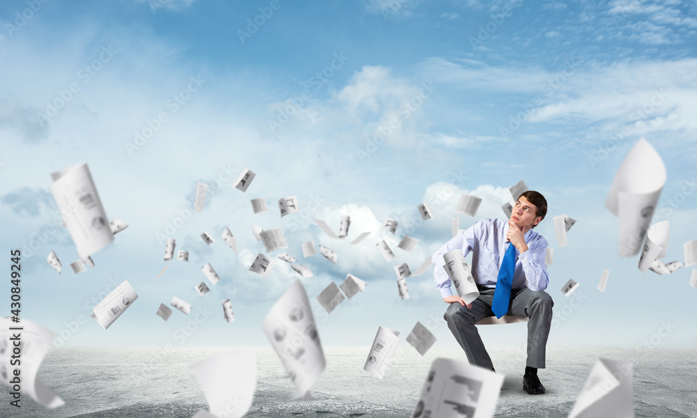 Young businessman sitting on an office chair Young businessman sitting on an office chair