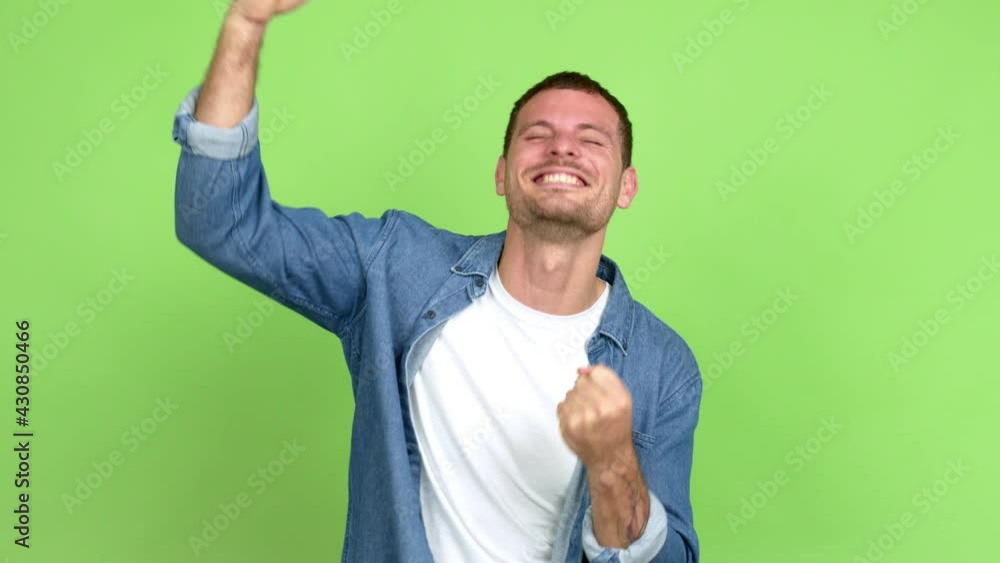 Brazilian handsome man celebrating a victory and surprised to be successful over isolated background Brazilian handsome man celebrating a victory and surprised to be successful over isolated background