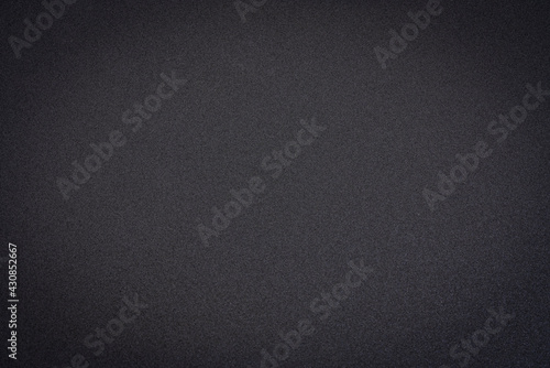 black acrylic sheet with non reflective matte finish, background and texture with a selective focus